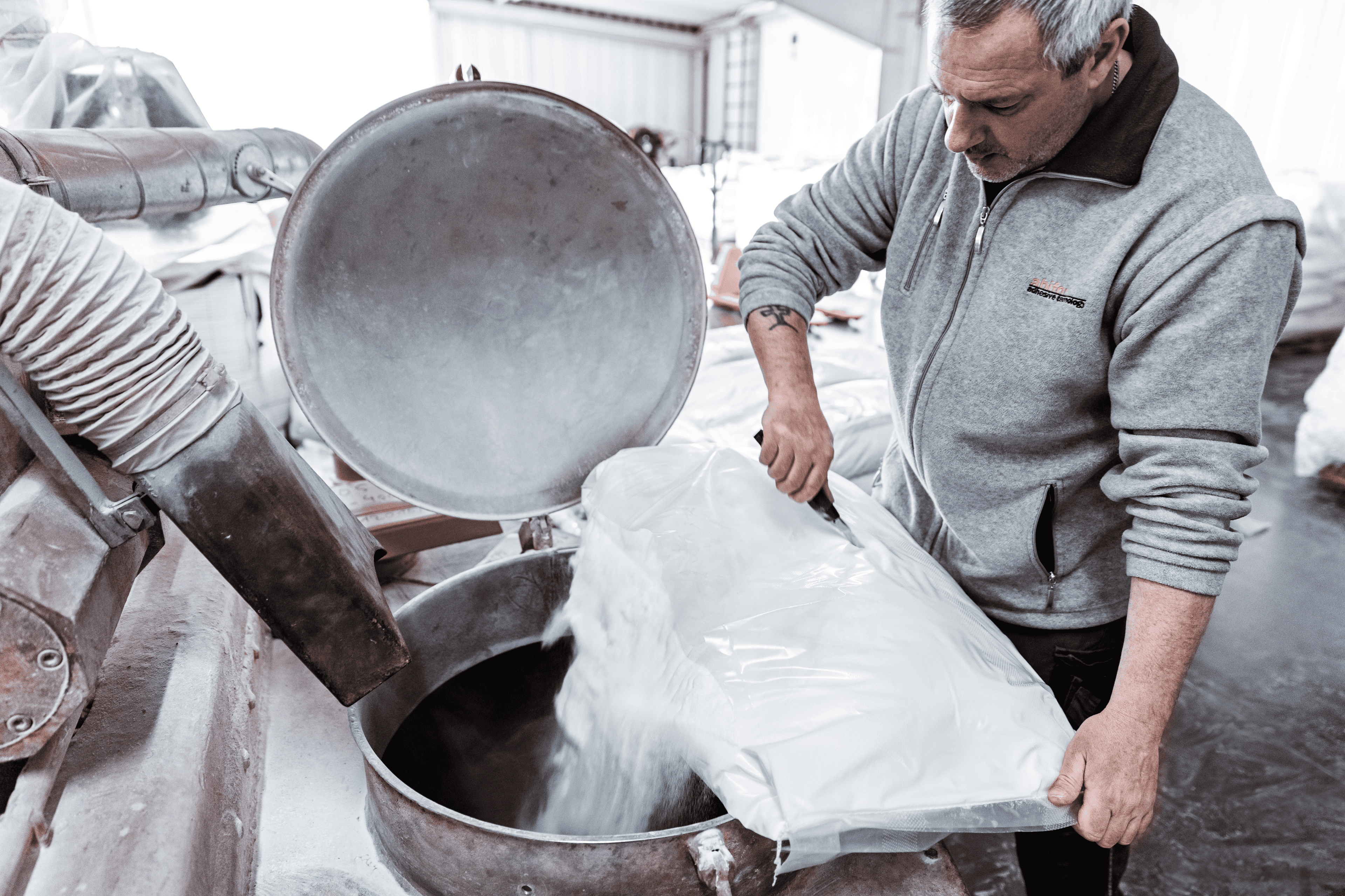Workers packaging finished polymer products on a production line